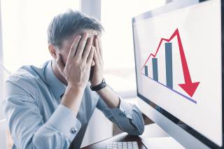 Foto: Gestresste Person und Chart mit Abwärtspfeil 